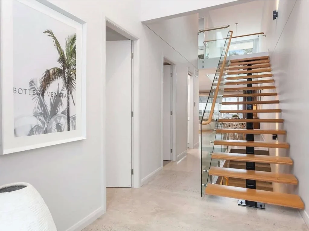 Timber and glass staircase in the Riverview Drive project imagery